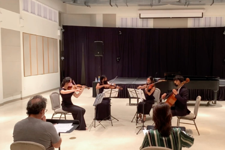 orchestra quartet (including Erika Miller) performing in studio while two others watch